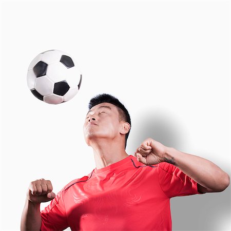 simsearch:6116-07086707,k - Footballer heading the ball, white background Stock Photo - Premium Royalty-Free, Code: 6116-07085154