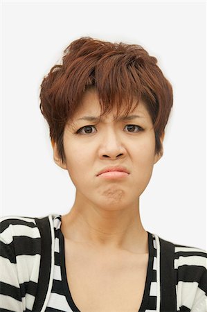 simsearch:400-03925541,k - Portrait of displeased young woman, studio shot Stock Photo - Premium Royalty-Free, Code: 6116-07085246