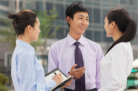 simsearch:6116-07086722,k - Three young business people talking outdoors, Beijing Stock Photo - Premium Royalty-Free, Code: 6116-07085296
