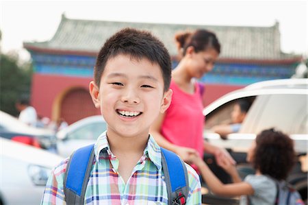 Portrait of boy with his family in the background Stock Photo - Premium Royalty-Free, Code: 6116-07085386
