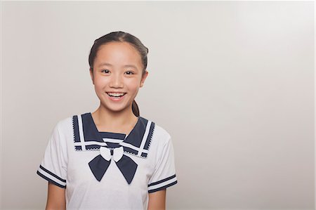 Girl smiling, Studio Stock Photo - Premium Royalty-Free, Code: 6116-07085395