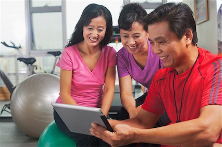 People looking at digital tablet in the gym Stock Photo - Premium Royalty-Free, Code: 6116-07085449