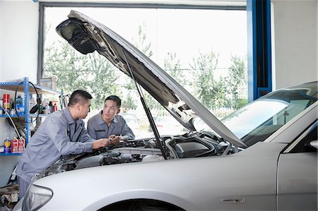 simsearch:6116-07085696,k - Two Garage Mechanics Working on Engine Stock Photo - Premium Royalty-Free, Code: 6116-07085683