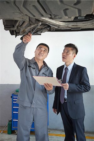 simsearch:6116-07085696,k - Mechanic Explaining to Businessman Stock Photo - Premium Royalty-Free, Code: 6116-07085704