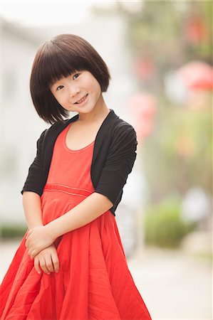 Portrait of Little Girl with Red Dress in Nanluoguxiang, Beijing, China Stock Photo - Premium Royalty-Free, Code: 6116-07085812