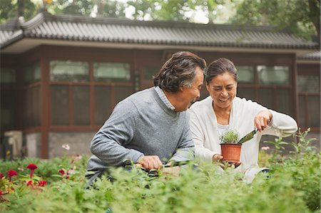 senior man gardening not child - Smiling senior couple in garden Stock Photo - Premium Royalty-Free, Code: 6116-07085992