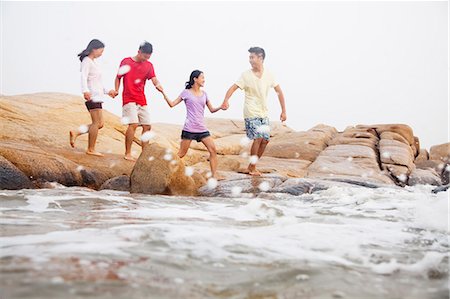 simsearch:6116-07085909,k - Four friends walking over rocks by the sea Stock Photo - Premium Royalty-Free, Code: 6116-07085929