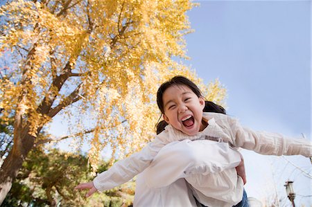 shout low angle - Grandfather and Granddaughter Playing in the Park Stock Photo - Premium Royalty-Free, Code: 6116-07086086