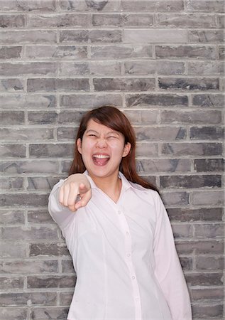 simsearch:400-03925541,k - Portrait of Young Woman Pointing Stock Photo - Premium Royalty-Free, Code: 6116-07086242