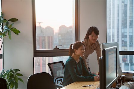 sunset interior - Two Businesswomen Working Together in the Office Stock Photo - Premium Royalty-Free, Code: 6116-07086230