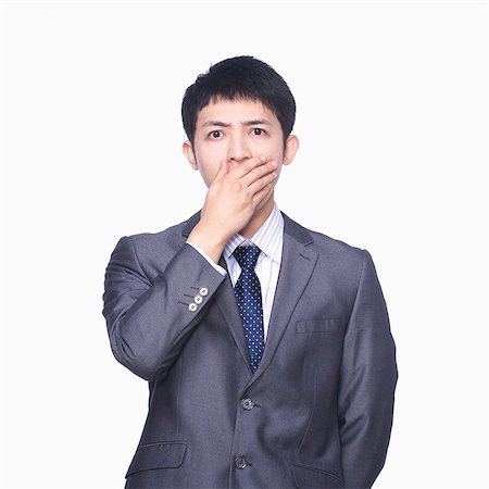 simsearch:6116-07086332,k - Businessman covering mouth with hand Stock Photo - Premium Royalty-Free, Code: 6116-07086342