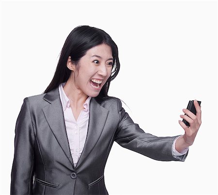 simsearch:6116-07086324,k - Businesswoman yelling at mobile phone Stock Photo - Premium Royalty-Free, Code: 6116-07086370