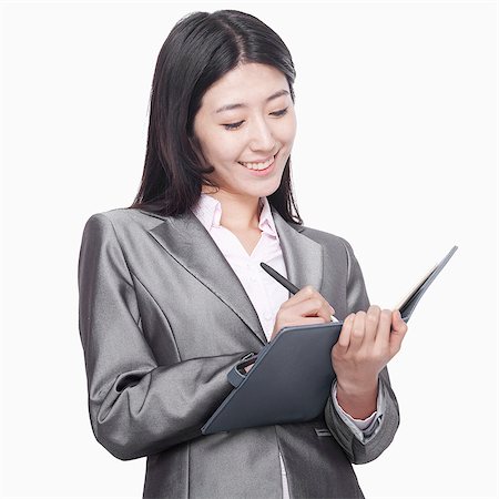 simsearch:6116-07086332,k - Businesswoman taking notes in her notebook Stock Photo - Premium Royalty-Free, Code: 6116-07086372