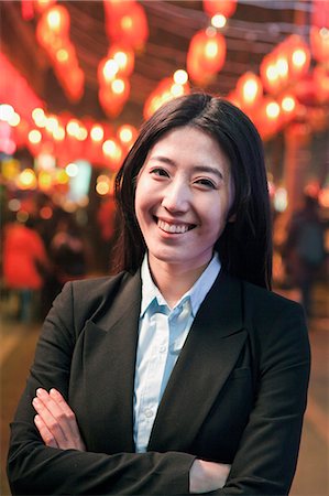 professional woman portrait - Businesswoman standing on the street, red lanterns on the background Stock Photo - Premium Royalty-Free, Code: 6116-07086385