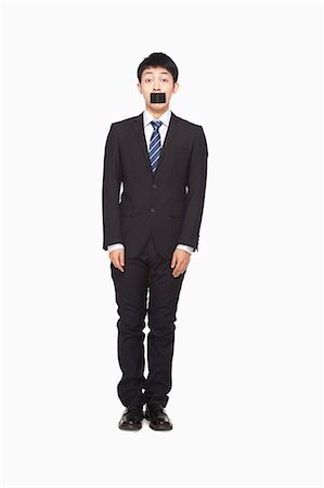 simsearch:6116-07086332,k - Businessman with black tape over mouth Stock Photo - Premium Royalty-Free, Code: 6116-07086307