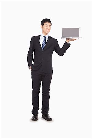 simsearch:6116-07086332,k - Businessman presenting laptop Stock Photo - Premium Royalty-Free, Code: 6116-07086312