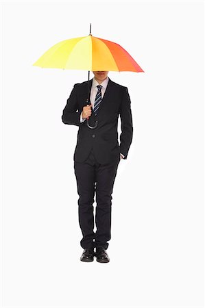 simsearch:6116-07086332,k - Businessman with hidden face under umbrella Stock Photo - Premium Royalty-Free, Code: 6116-07086316