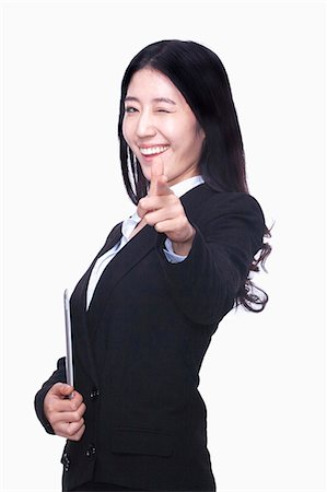 simsearch:6116-07086332,k - Businesswoman pointing finger like gun Stock Photo - Premium Royalty-Free, Code: 6116-07086338