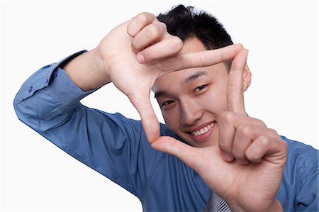 smiling laughing beauty - Businessman Framing His Face Stock Photo - Premium Royalty-Free, Code: 6116-07086448