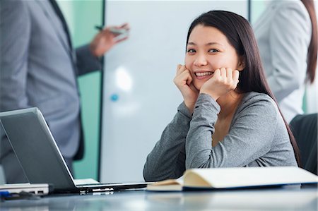 suit business people meeting laptop ethnic - Young Businesswoman Looking at Camera Stock Photo - Premium Royalty-Free, Code: 6116-07086554