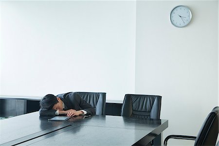 Businessman sleeping in office room Stock Photo - Premium Royalty-Free, Code: 6116-07086520