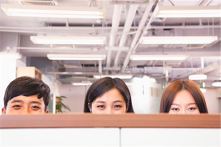 simsearch:6116-07086722,k - Office workers peeking over divider in office Stock Photo - Premium Royalty-Free, Code: 6116-07086771