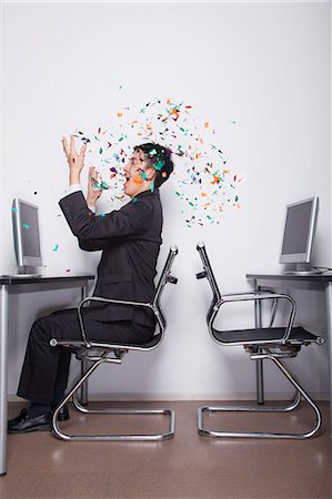 simsearch:6116-07086722,k - Young Businessman throwing confetti in the office Stock Photo - Premium Royalty-Free, Code: 6116-07086734