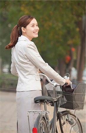 simsearch:649-08145347,k - Young Business Woman standing with a Bicycle, Beijing, China Stock Photo - Premium Royalty-Free, Code: 6116-07235360