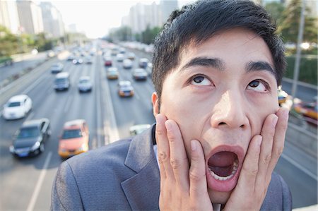 environmental pollution - Young Angry Businessman Yelling Over Freeway Foto de stock - Sin royalties Premium, Código: 6116-07235387