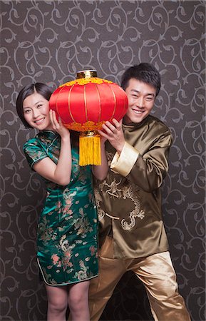 Young Couple Holding Chinese Lantern in Traditional Clothing Stock Photo - Premium Royalty-Free, Code: 6116-07235542