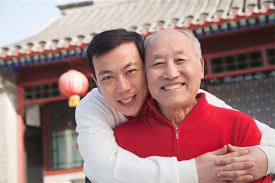 Portrait of father and son outside traditional Chinese building Stock Photo - Premium Royalty-Free, Image code: 6116-07235554