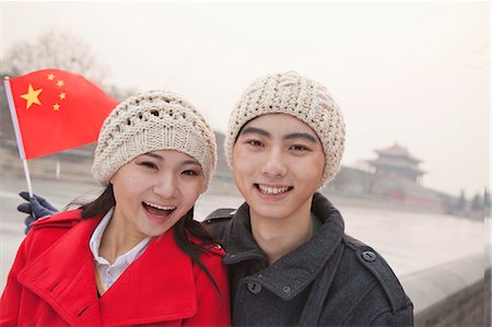 simsearch:6116-07235527,k - Portrait of young couple holding Chinese flag outdoors in wintertime, Beijing Photographie de stock - Premium Libres de Droits, Code: 6116-07235565