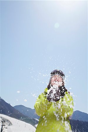 snowballs - Young Woman Playing with Snow in the Mountains Stock Photo - Premium Royalty-Free, Code: 6116-07235572