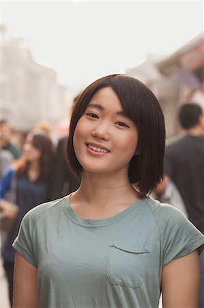 simsearch:6116-07235632,k - Young Woman smiling and looking at camera Stock Photo - Premium Royalty-Free, Code: 6116-07235641