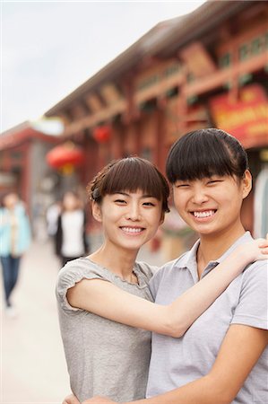 simsearch:6116-07235662,k - Two friends laughing and embracing Stock Photo - Premium Royalty-Free, Code: 6116-07235649