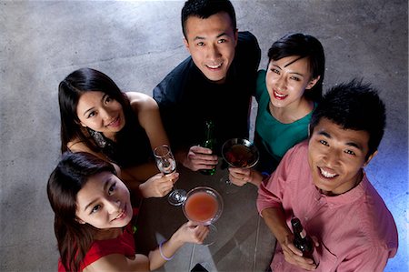 A group of friends having drinks in nightclub Stock Photo - Premium Royalty-Free, Code: 6116-07235654