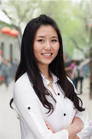 simsearch:6116-07235632,k - Young Woman smiling and looking at camera Stock Photo - Premium Royalty-Free, Code: 6116-07235625