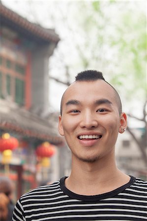 simsearch:6116-07235632,k - Young Man with Mohawk haircut smiling looking at camera Stock Photo - Premium Royalty-Free, Code: 6116-07235634