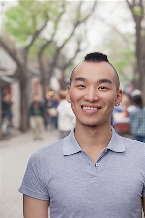 simsearch:6116-07235632,k - Young Man with Mohawk haircut smiling looking at camera Stock Photo - Premium Royalty-Free, Code: 6116-07235636