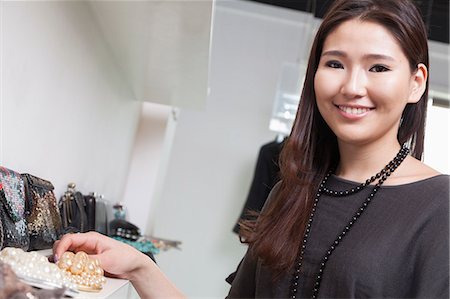 simsearch:6116-06938959,k - Young woman shopping for accessories at store, portrait Stock Photo - Premium Royalty-Free, Code: 6116-07235750
