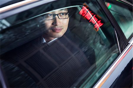 peking night people - Contemplative businessman looking through car window at the night Stock Photo - Premium Royalty-Free, Code: 6116-07235790