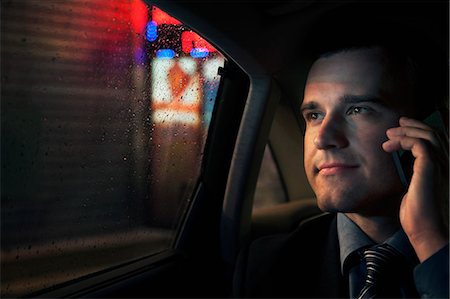 person car rain - Contemplative Businessman on the phone in the back seat of a car looking out at night in Beijing Stock Photo - Premium Royalty-Free, Code: 6116-07235797