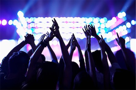 stage people - Audience watching a rock show, hands in the air, rear view, stage lights Stock Photo - Premium Royalty-Free, Code: 6116-07236049