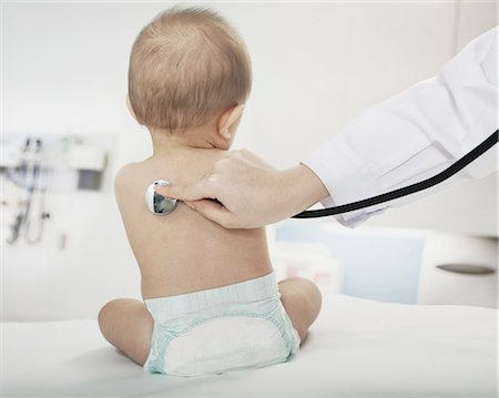 Baby sitting in the doctors office with the doctors hand checking heart beat with a stethoscope Stock Photo - Premium Royalty-Free, Code: 6116-07236014