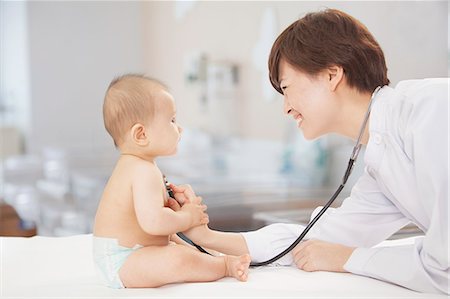 simsearch:6116-07236099,k - Doctor checking baby's heart beat with a stethoscope in the doctors office Stock Photo - Premium Royalty-Free, Code: 6116-07236015