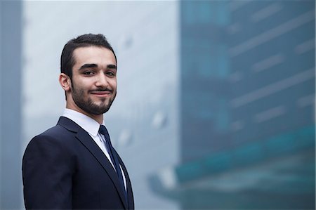 simsearch:6116-07236288,k - Portrait of smiling young businessman, outdoors, business district Stockbilder - Premium RF Lizenzfrei, Bildnummer: 6116-07236290