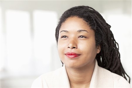 Portrait of smiling businesswoman with dreadlocks, head and shoulders Stock Photo - Premium Royalty-Free, Code: 6116-07236461