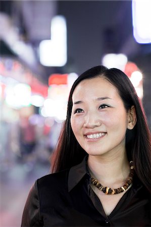 people metro - Smiling woman out at night in the city, portrait Stock Photo - Premium Royalty-Free, Code: 6116-07236492