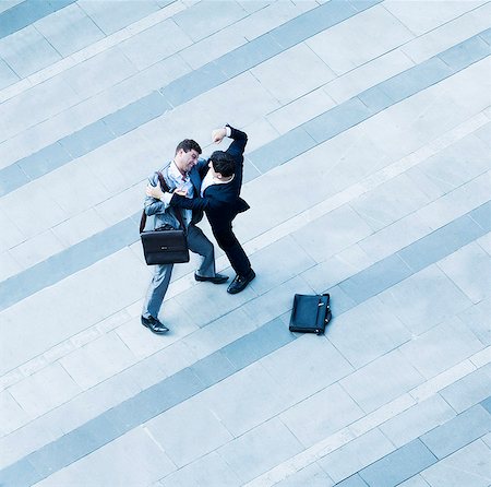 furious - Aerial view of two businessmen fighting each other of the sidewalk Stock Photo - Premium Royalty-Free, Code: 6116-07236565