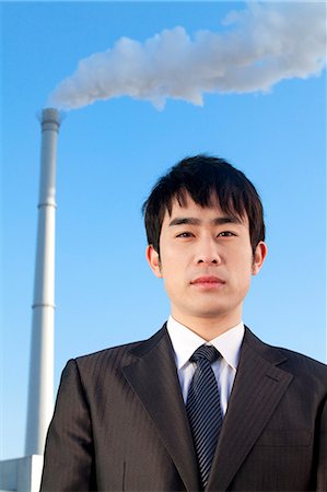 simsearch:649-08561987,k - Businessman in Front of Smokestack Stock Photo - Premium Royalty-Free, Code: 6116-08311883